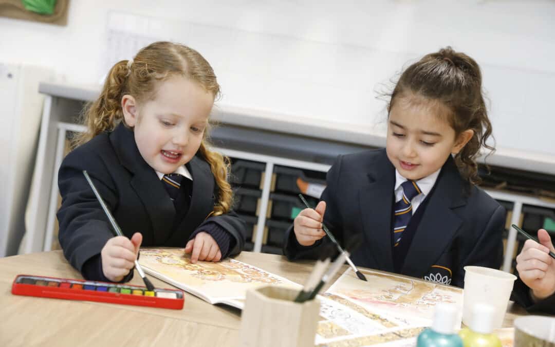 Two reception pupils painting pictures at Crown Street Primary School.